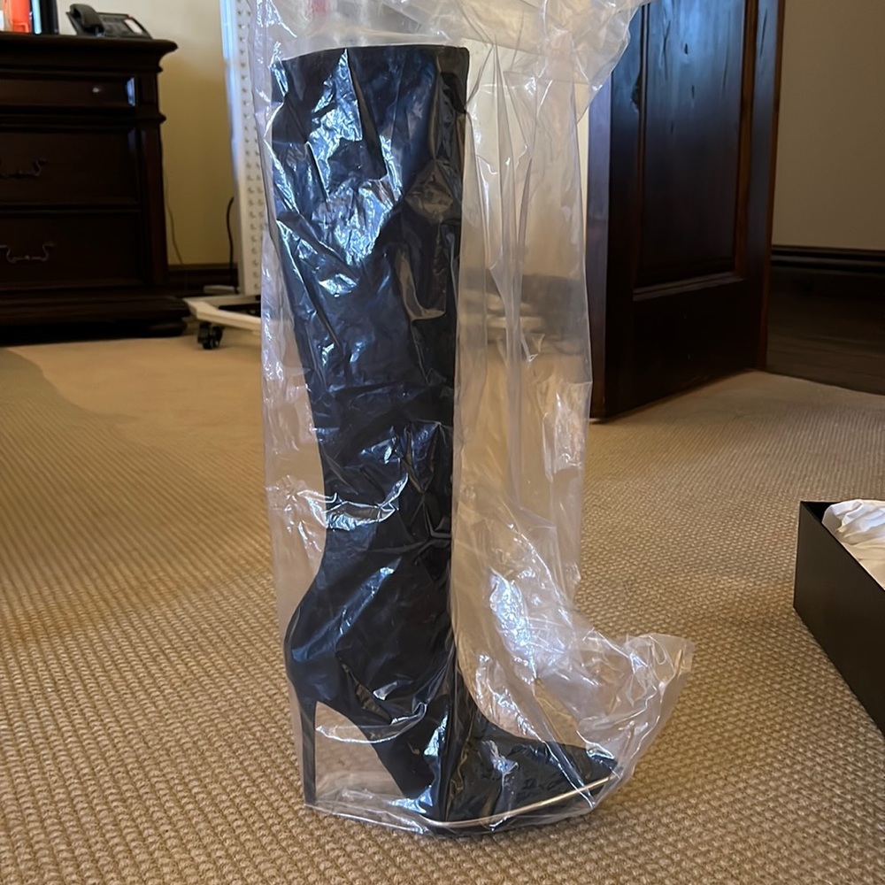 Alexander Wang black suede boots width metal silver trim around the tow box.